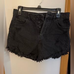 Black denim shorts with ruffles on bottom.